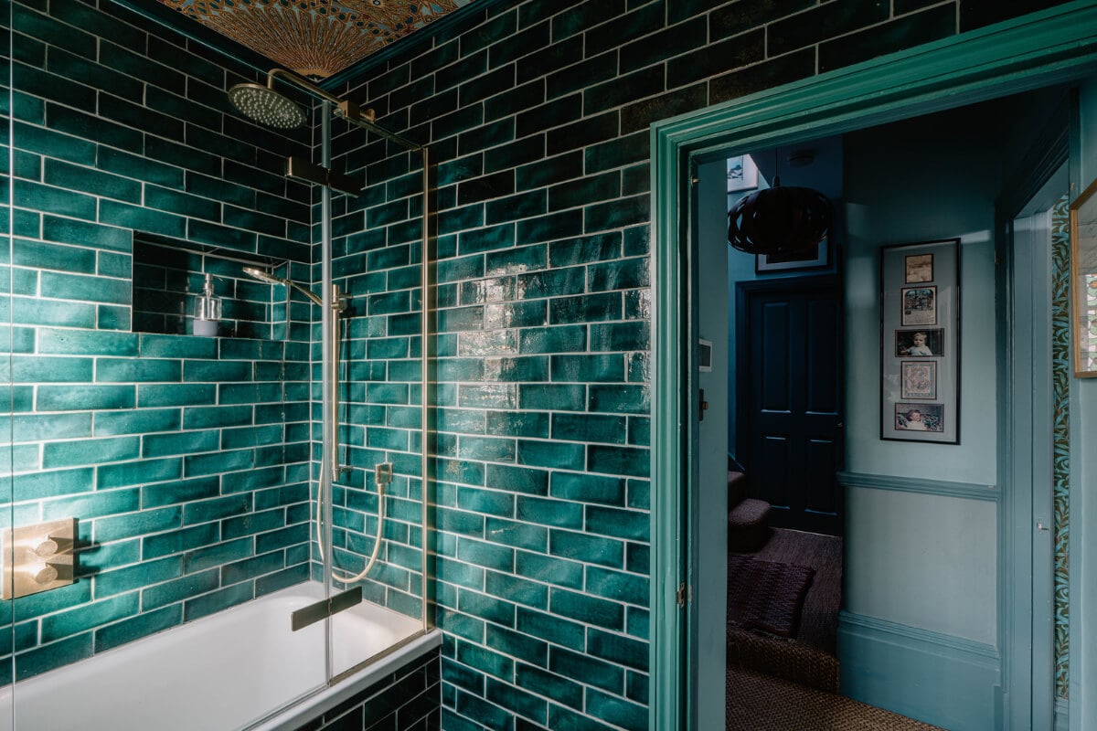 Moroccan-Inspired Designs in a Unique Artist Family Home in London 26 dark green tiles bathroom