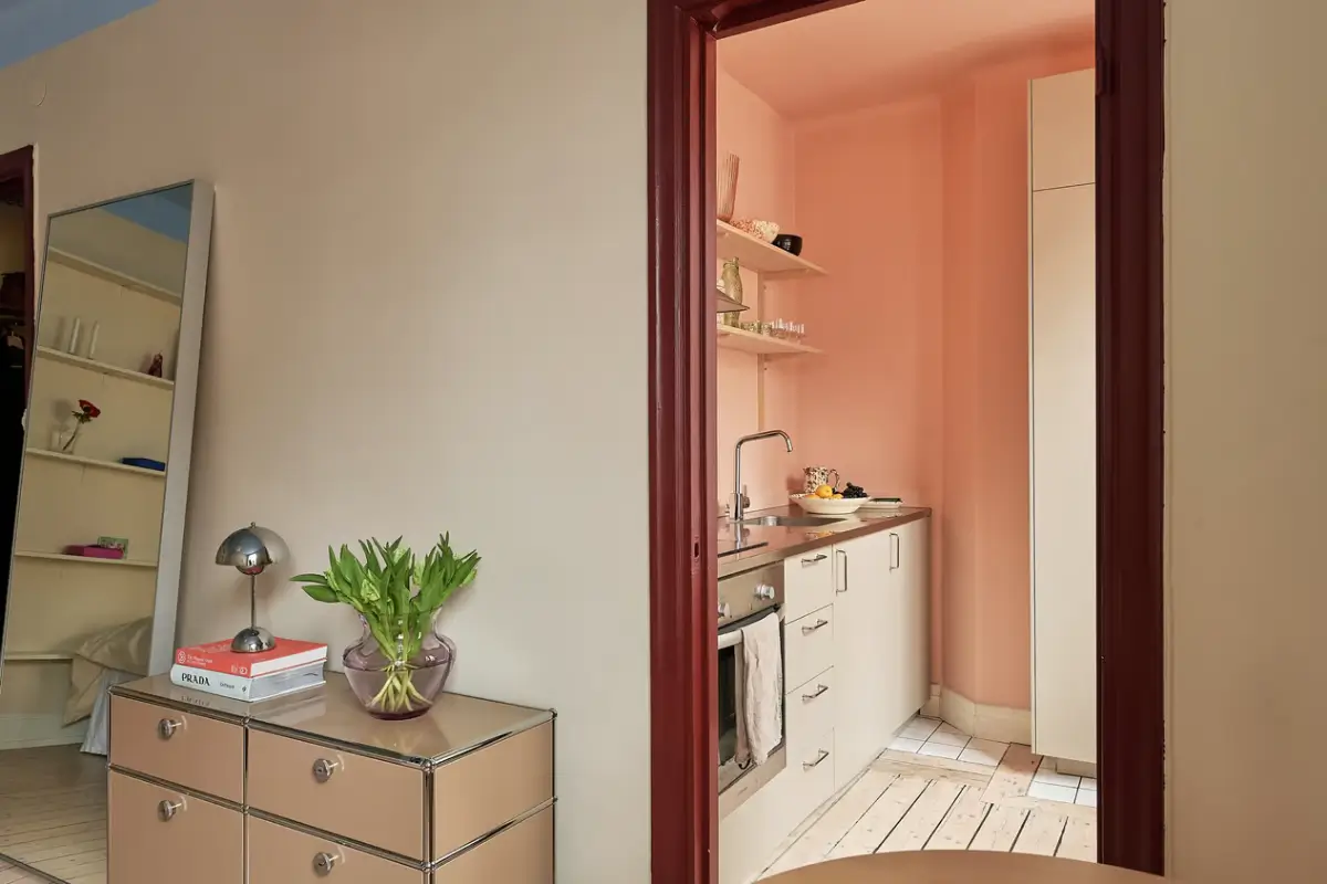 A Colorful Studio Apartment in Stockholm 8 dark pink painted doorframe A Colorful Studio Apartment in Stockholm