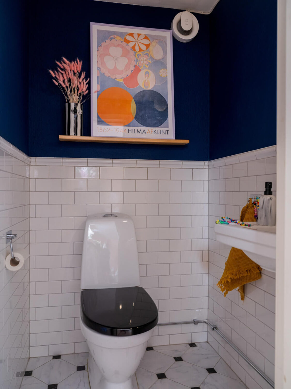 Colorful Decor in a Charming Family Duplex Apartment in Stockholm 28 deep blue walls powder room