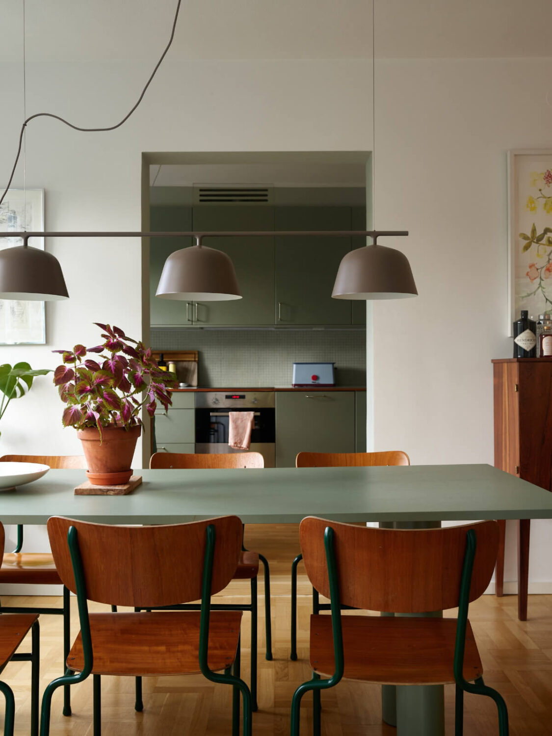 A Lovely Color Palette in a Midcentury Apartment in Sweden 12 dining area view into kitchen