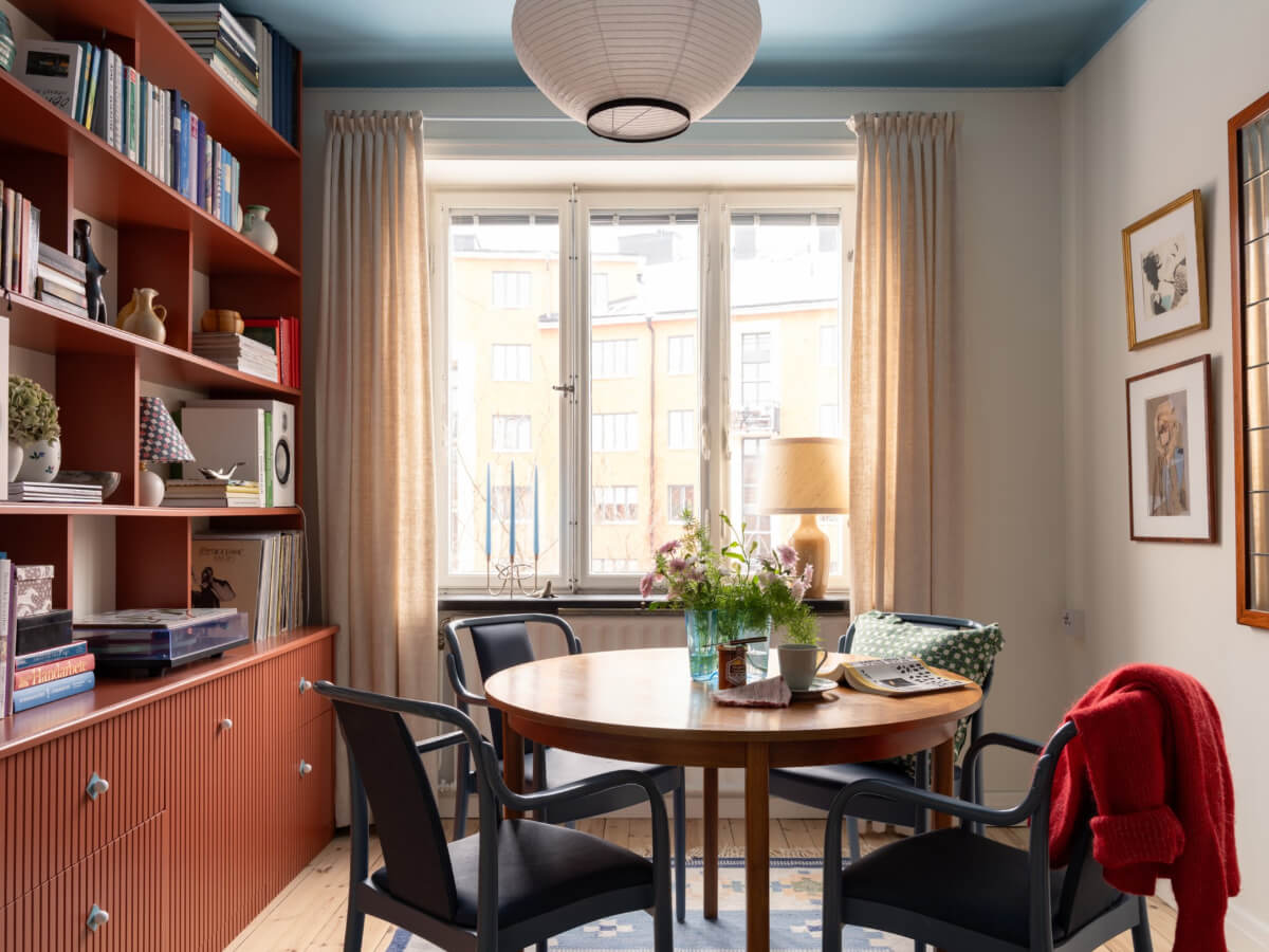 A Beautiful Well-Preserved 1930s Apartment with a Blue Kitchen 9 dining room blue ceiling orange-red bookcase