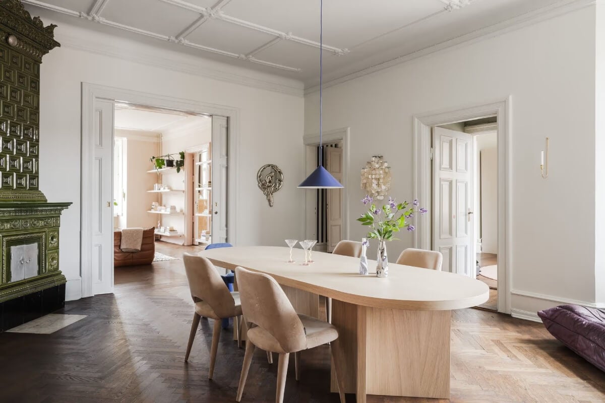 Grand Rooms and Period Features in a Malmö Apartment 10 dining room green fireplace blue pendant