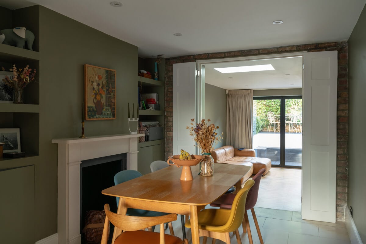 Contemporary Interiors and Preserved Details in an Early Victorian House 6 dining room green walls fireplace