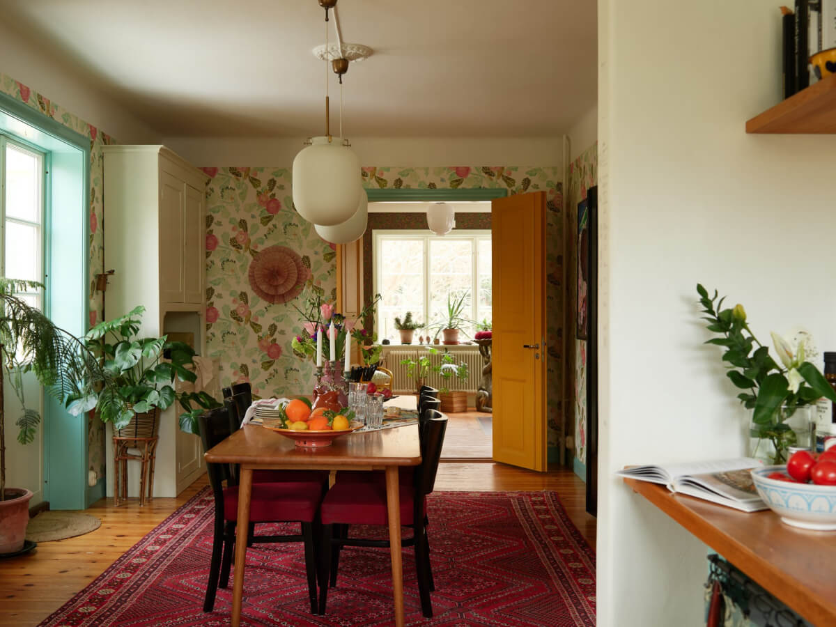 Colorful Interiors in a Wonderful Early 20th Century Swedish Villa 5 dining room large pink rug yellow doors
