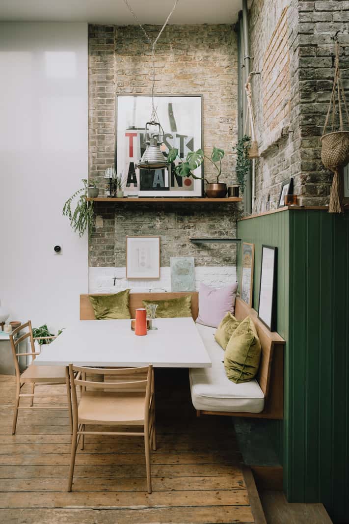 A London Basement Apartment in a Former Wood Workshop 9 dining table built-in bench exposed brick