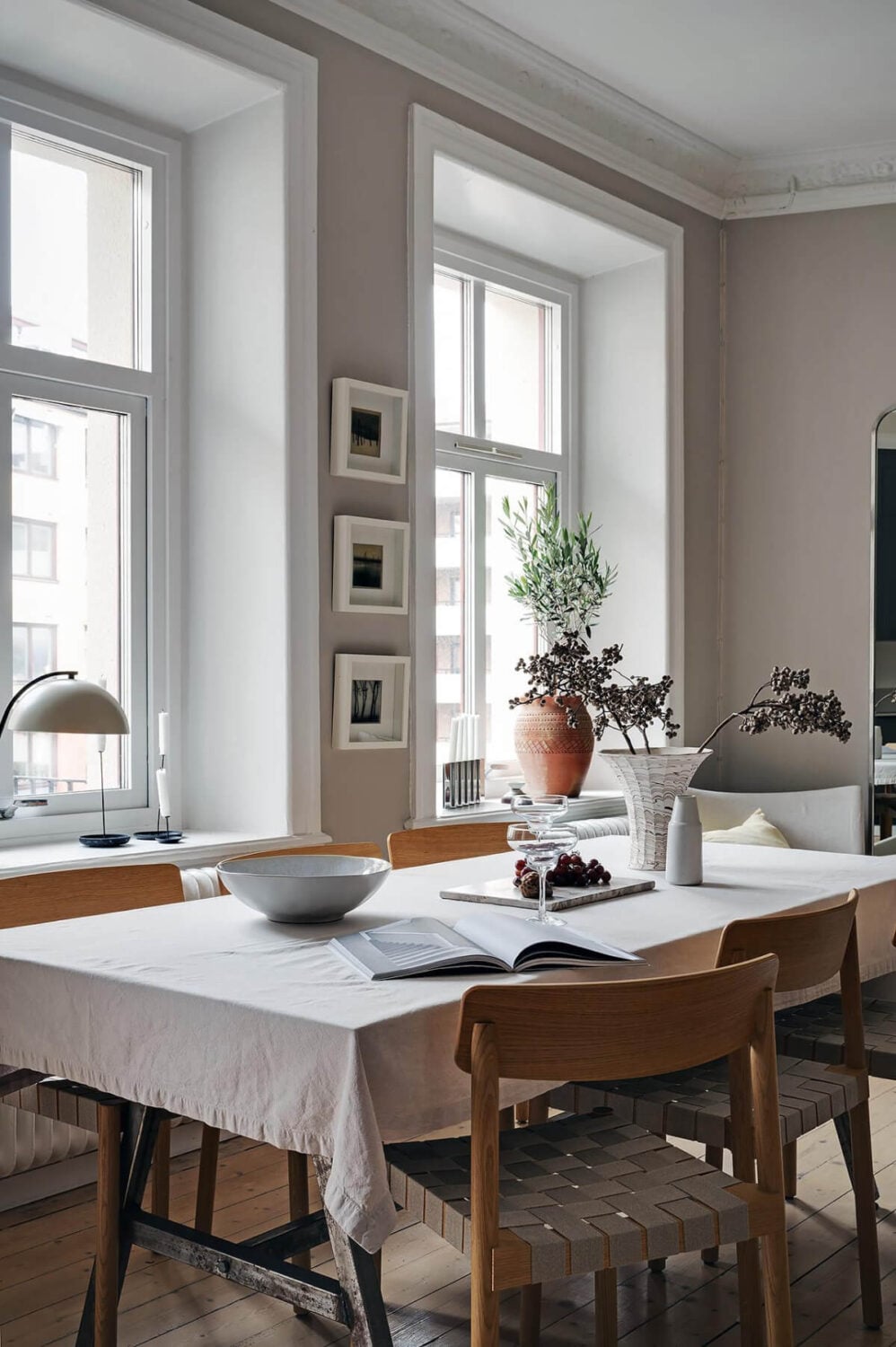 A Gothenburg Apartment with a Small Dark Green Bedroom 9 dining table large windows