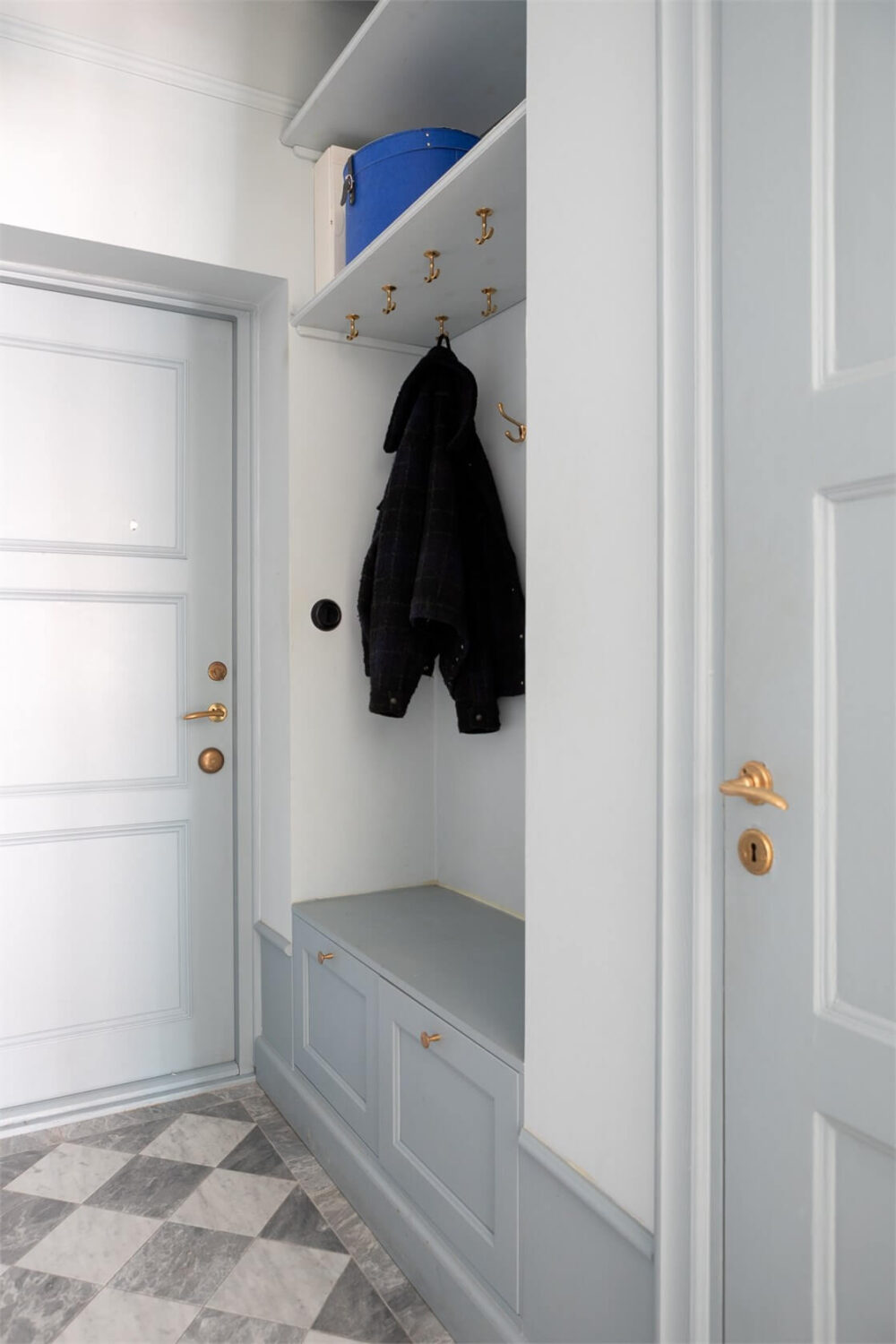 A Small Stockholm Apartment with a Blue Shaker Kitchen 26 entry with bench and hat shelf marble checkerboard floor A Small Stockholm Apartment with a Blue Shaker Kitchen