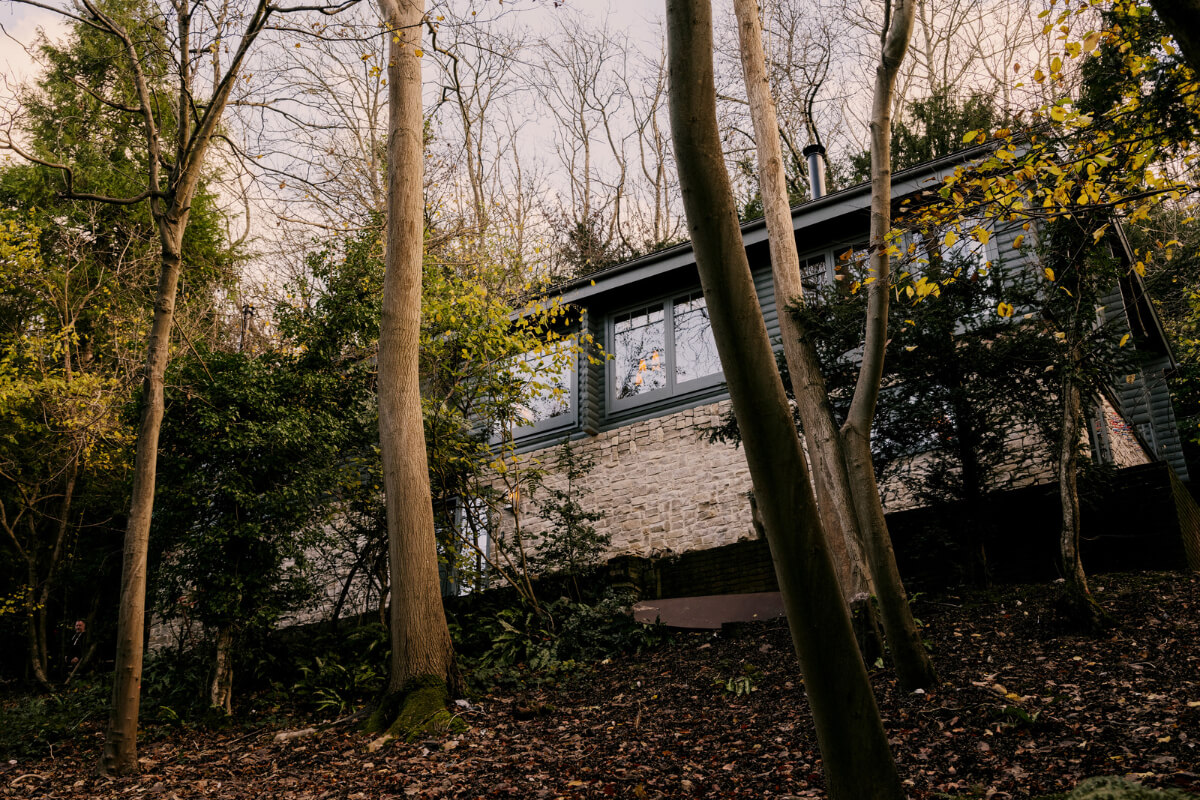 A Cozy and Contemporary Take on a Traditional Log House 20 exterior english house surrounded by trees