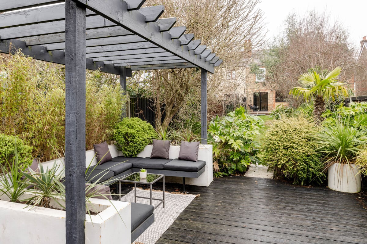 A Contrasting Color Palette in a Renovated Terrace House 19 garden pergola seating area