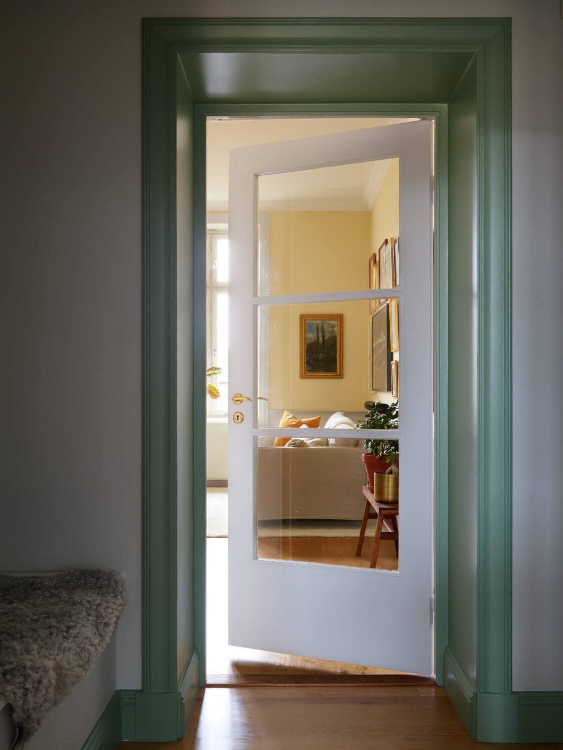 Lovely Color Combinations in a Charming One-Bedroom Apartment 9 glass-door-green-painted-doorway