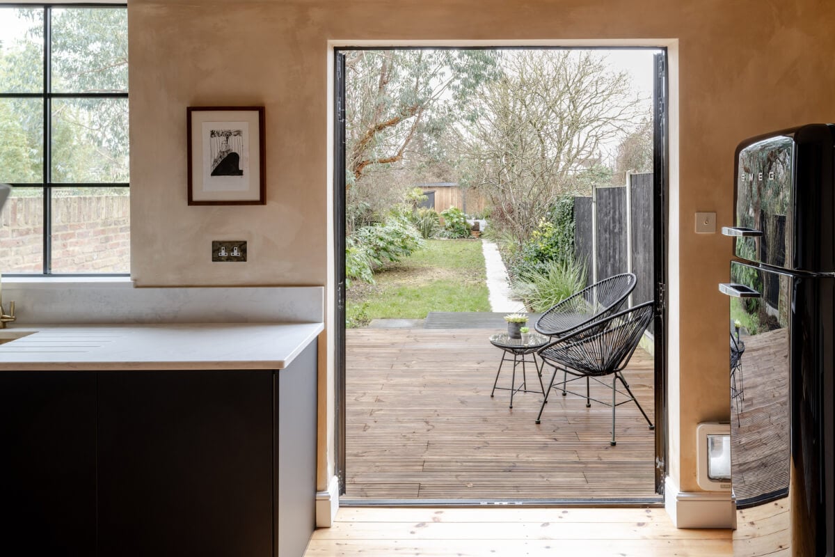 A Contrasting Color Palette in a Renovated Terrace House 8 glass kitchen doors to garden