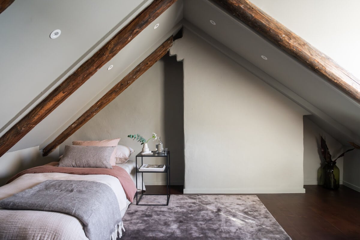 A Light Penthouse Apartment with Built-In Bookshelves 29 gray attic bedroom rustic wooden beams