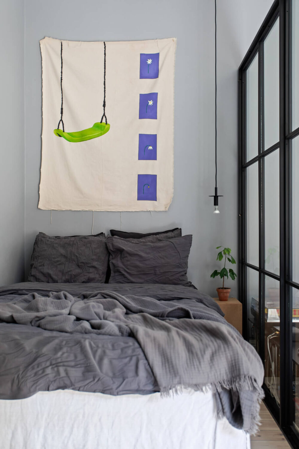 A Gray Studio Apartment with an Industrial Room Divider 9 gray bed nook simple pendan light