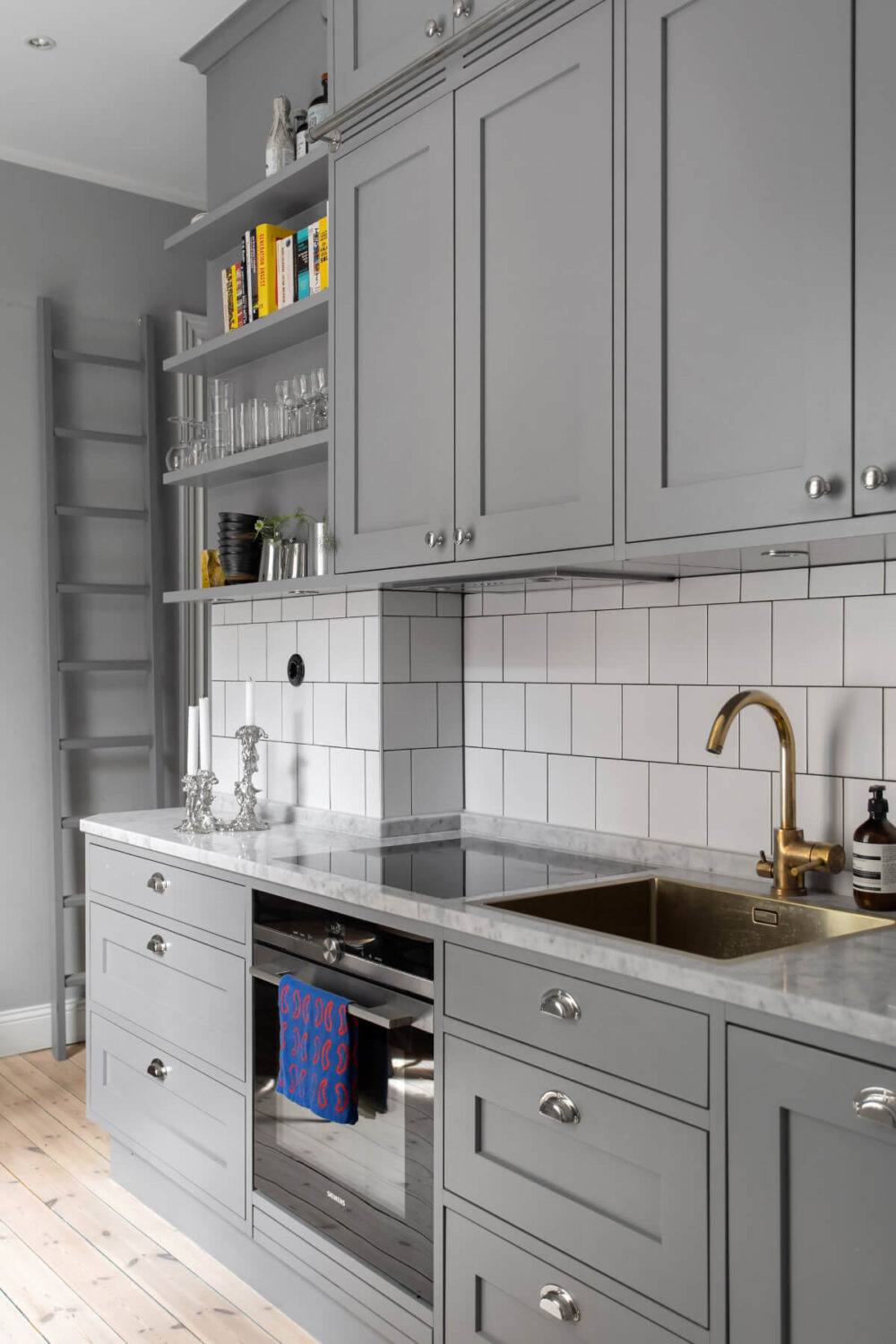 A Gray Studio Apartment with an Industrial Room Divider 11 gray kitchen double row upper cabinets shelves