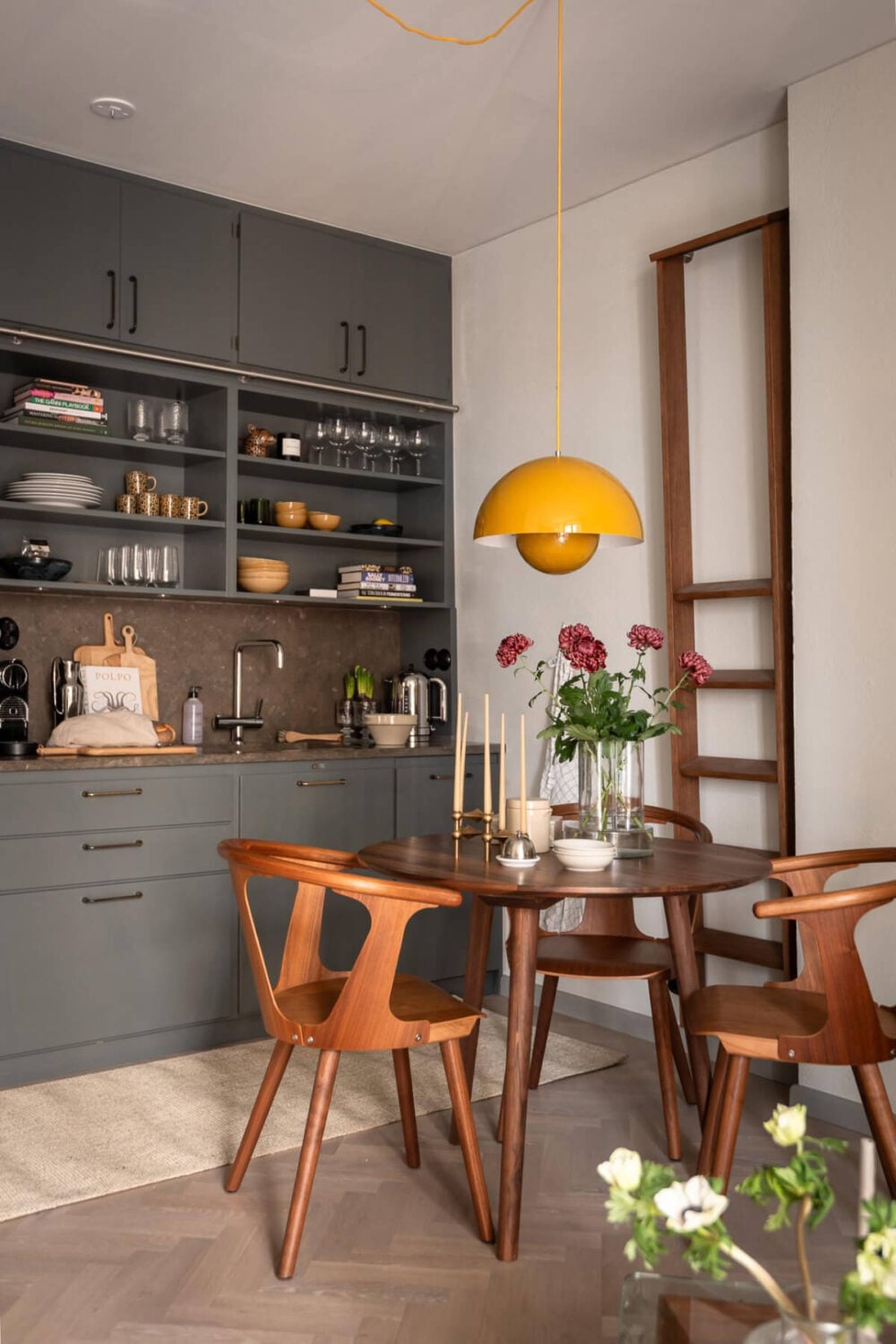 A Small Ground Floor Apartment Decorated in Gray Tones 5 gray kitchen round wooden table yellow pendant