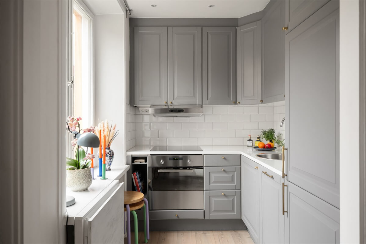 A Studio Apartment with Brown Walls 9 gray kitchen white tiles