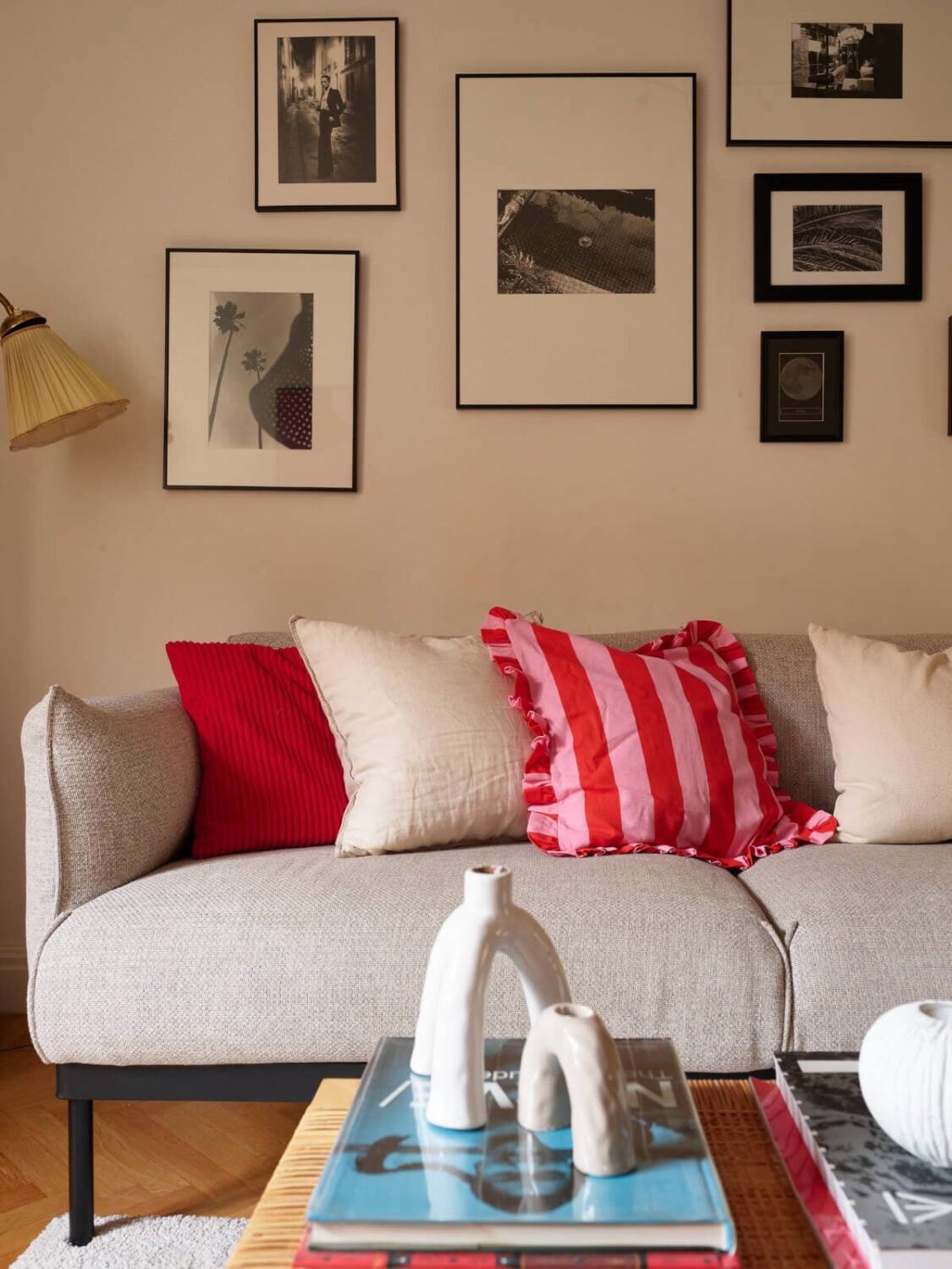 A Charming Small Apartment with a Fresh White Kitchen 3 gray sofa colorful cushions