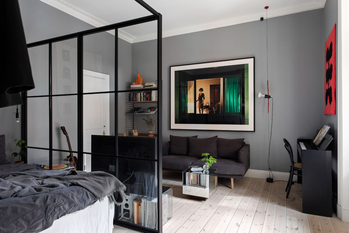 A Gray Studio Apartment with an Industrial Room Divider 1 gray studio steel glass room divider
