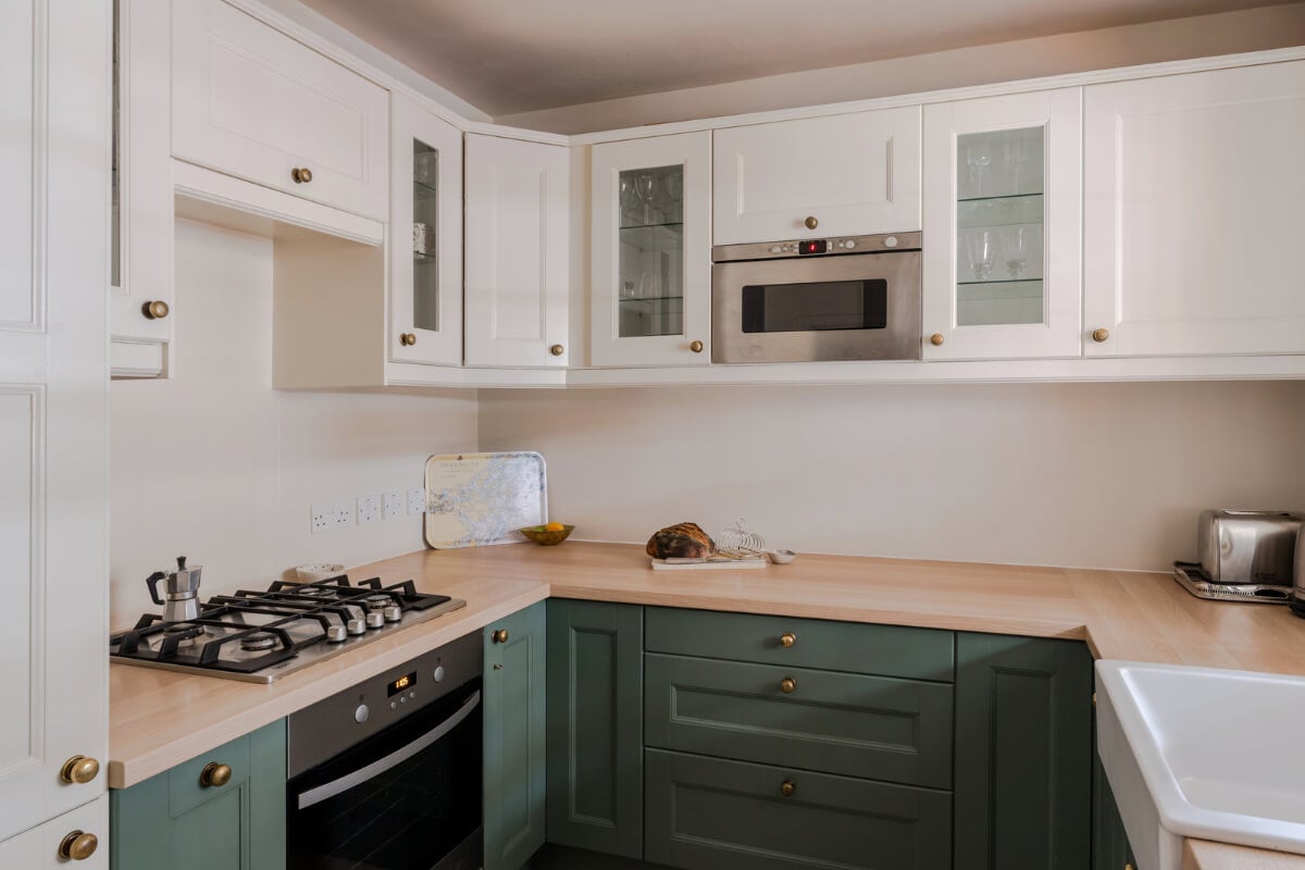 A Calm & Stylish Color Palette in a Small London Apartment 10 green and white kitchen brass knobs