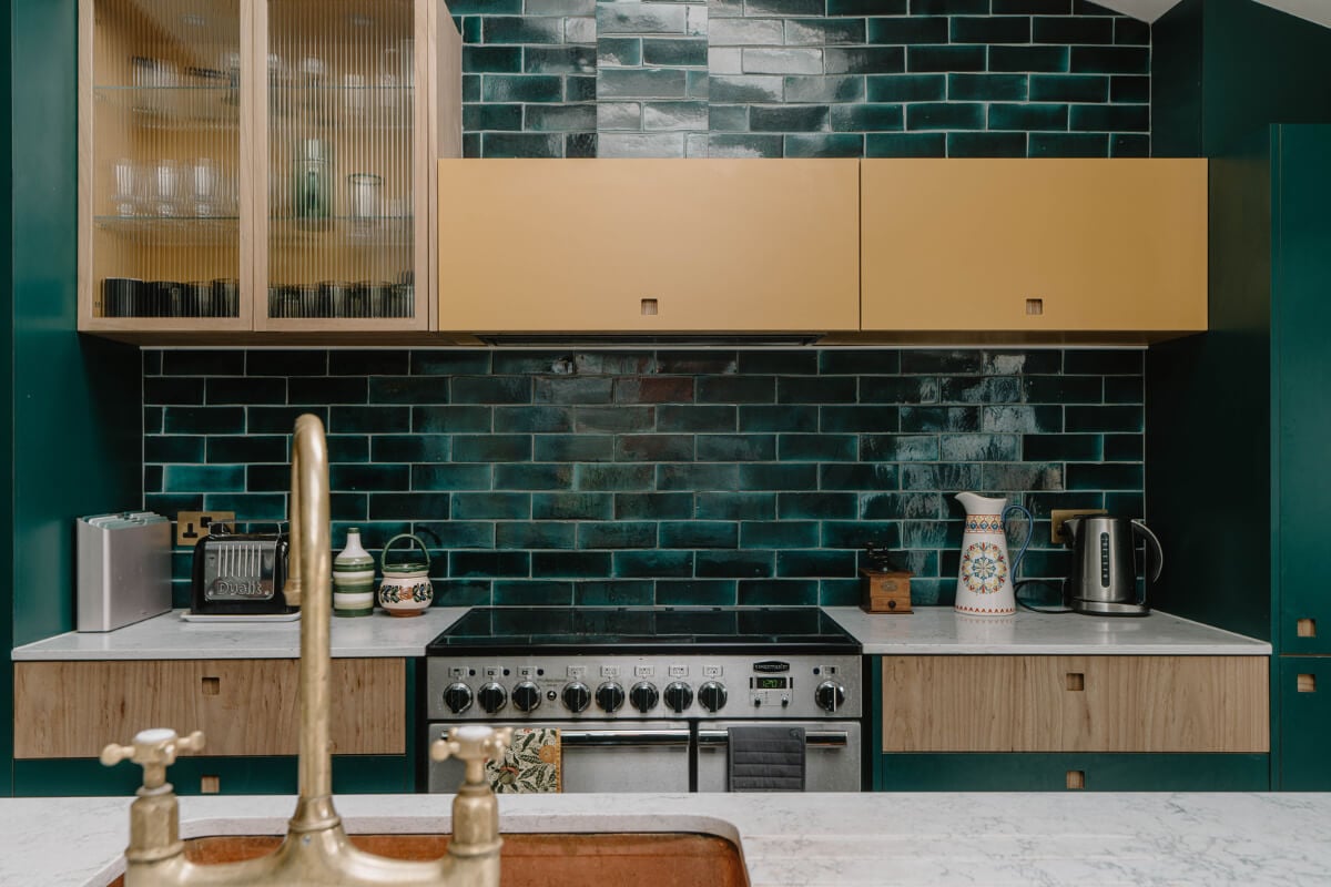 Moroccan-Inspired Designs in a Unique Artist Family Home in London 9 green backsplash tiles modern kitchen