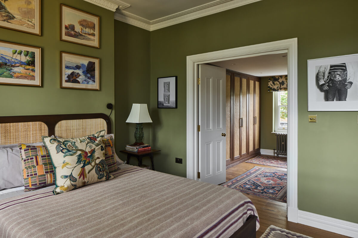 A Renovated Early Victorian Townhouse Decorated in Green Tones 14 green bedroom with en-suite wardrobe room