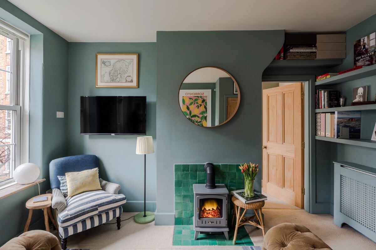 A Calm & Stylish Color Palette in a Small London Apartment 2 green fireplace tiles small blue living room