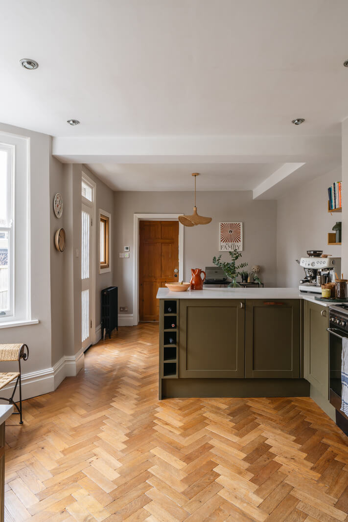 A Charming Garden Apartment in a Victorian House 5 green kitchen bay window wooden floor herringbone