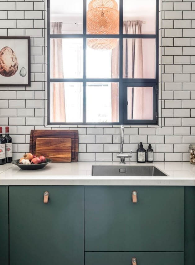 A Small Light-Filled Apartment with a Pink Bedroom 14 green kitchen cabinets inner window