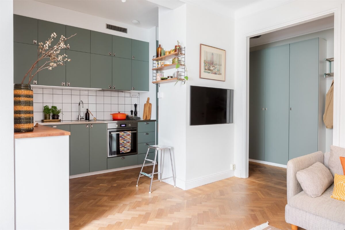 A Small Open-Plan Apartment with Midcentury Furniture 9 green kitchen open layout