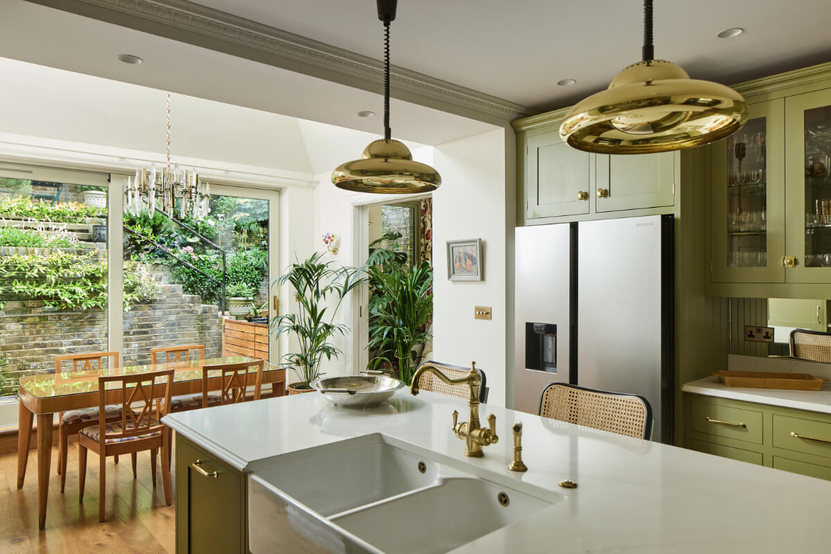 A Renovated Early Victorian Townhouse Decorated in Green Tones 4 green kitchen with dining table