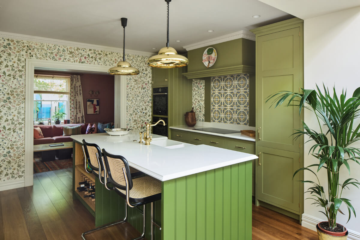A Renovated Early Victorian Townhouse Decorated in Green Tones 3 green-kitchen-with-island-floral-wallpaper