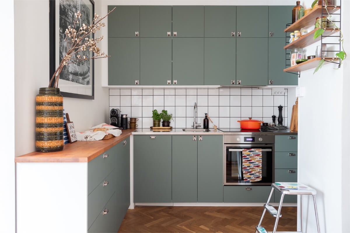 A Small Open-Plan Apartment with Midcentury Furniture 10 green midcentury style kitchen white tiles