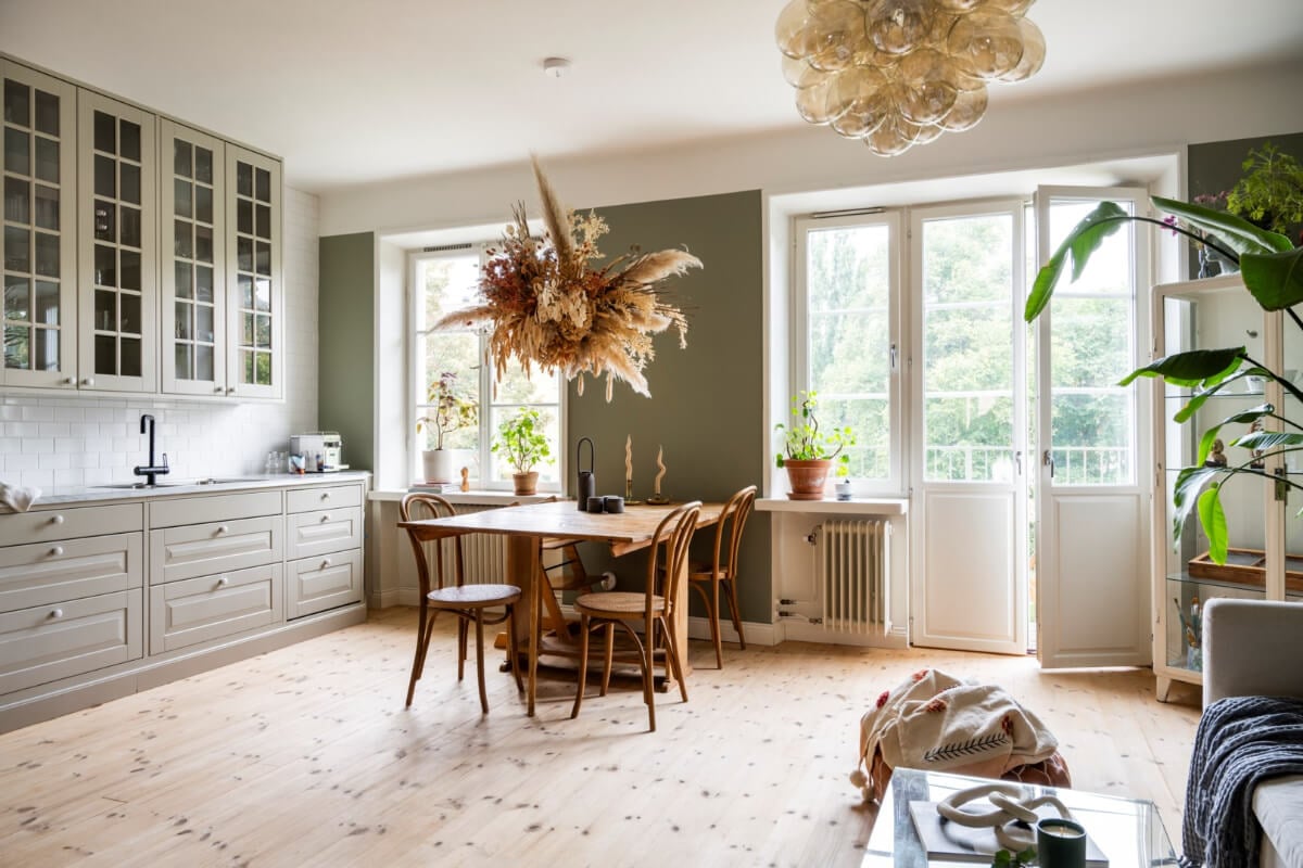 A Light Swedish Apartment with a Green Living Room 4 green open plan living space wooden floor