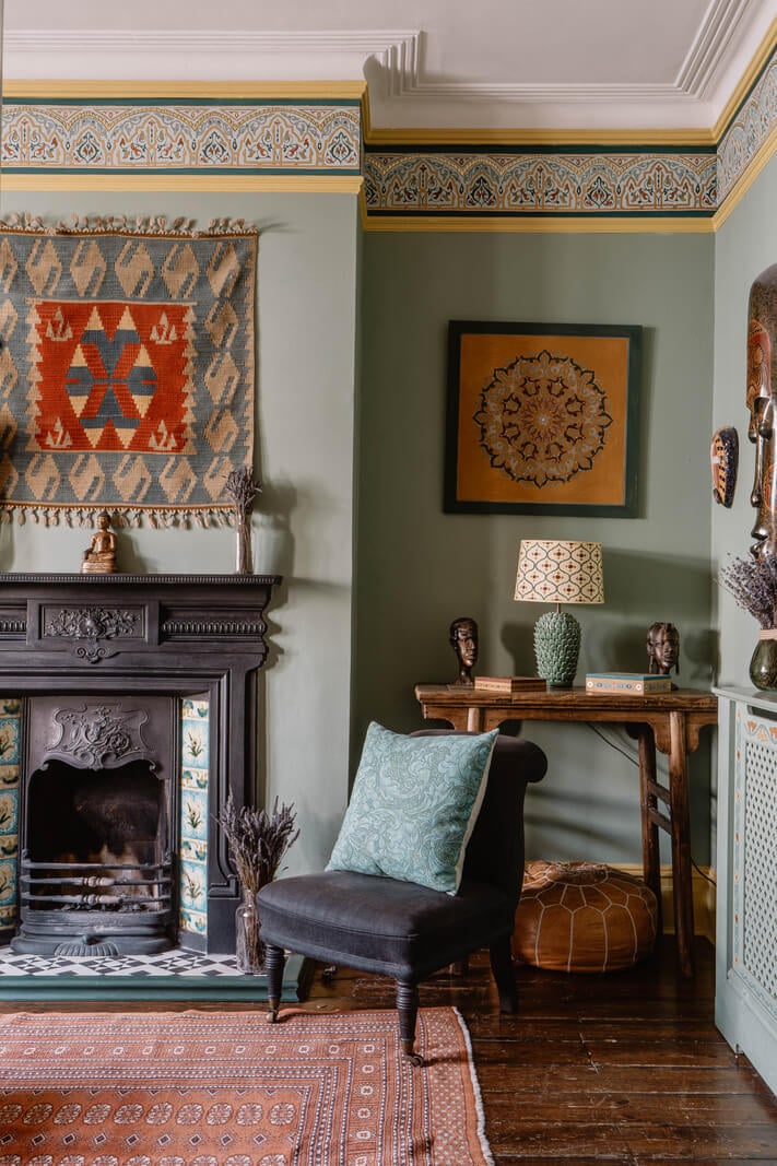 Moroccan-Inspired Designs in a Unique Artist Family Home in London 4 green sitting room with decorative painted molding