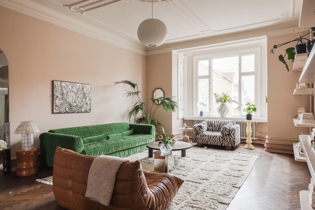 Grand Rooms and Period Features in a Malmö Apartment 2 green sofa pink living room