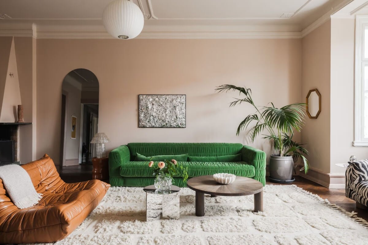 Grand Rooms and Period Features in a Malmö Apartment 5 green sofa spacious pink living room