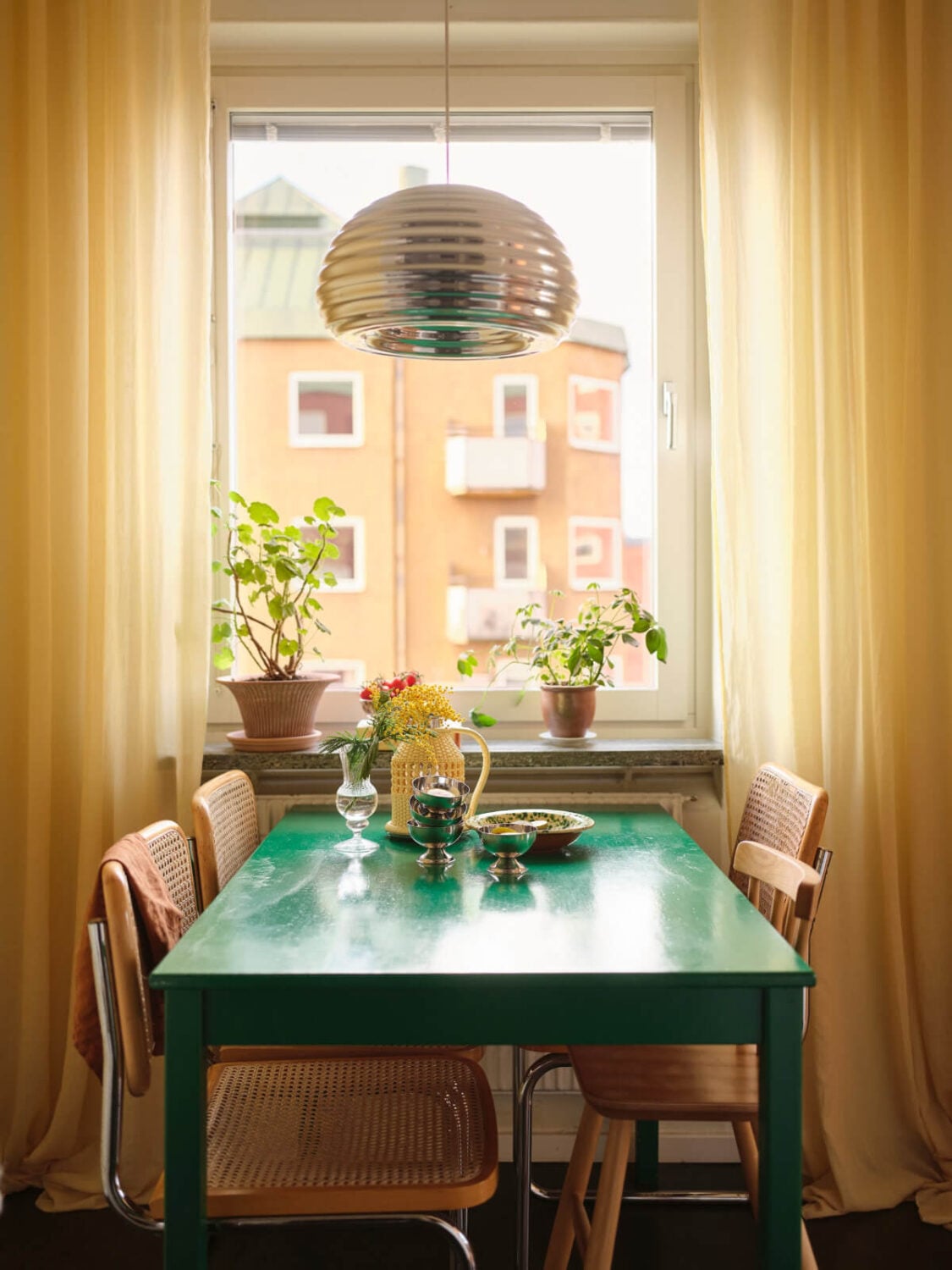 A Light Corner Apartment with Yellow Color Accents 14 green table yellow curtains