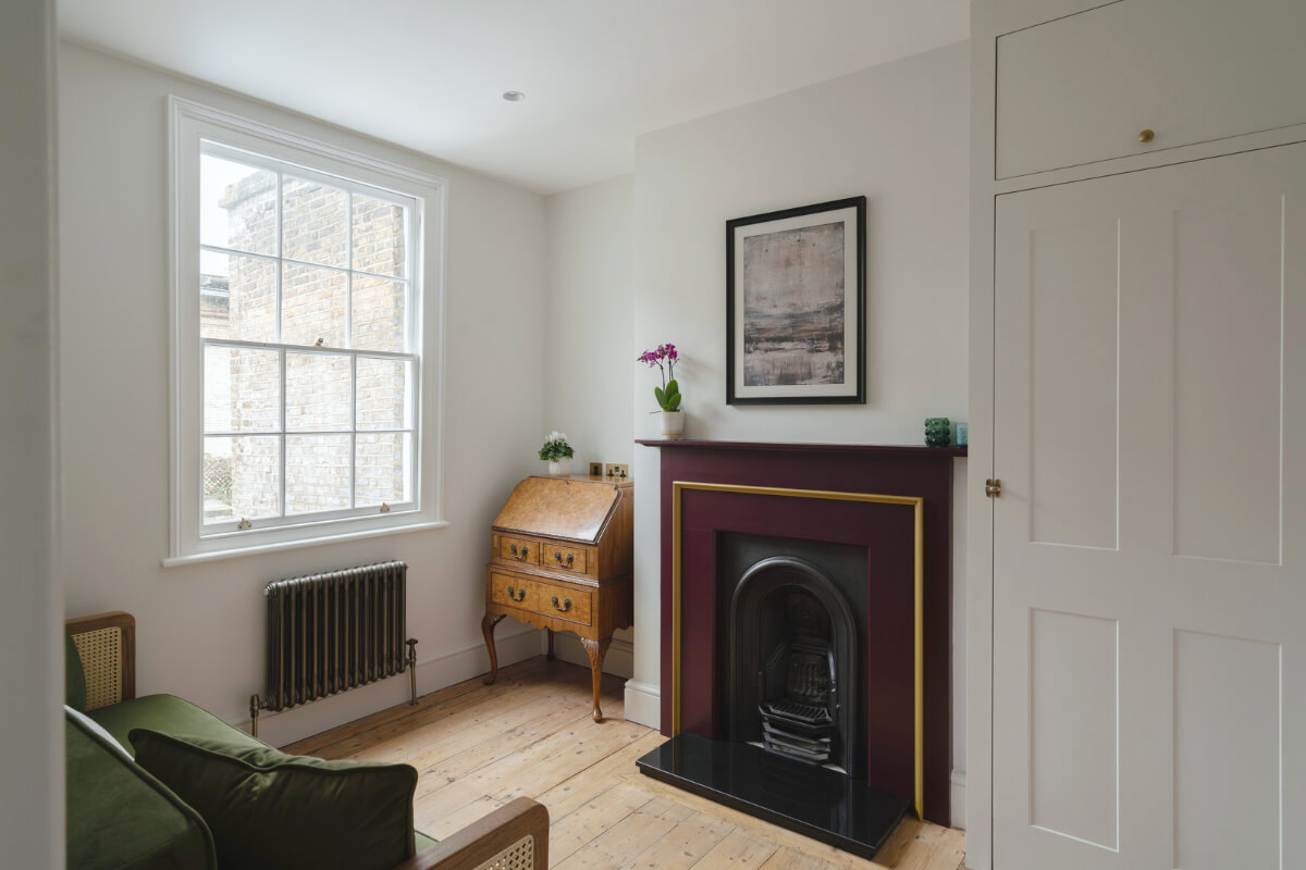 A Renovated Georgian House with an Extended Kitchen 21 guest-room-deep-red-fireplace-built-in-wardrobes.jpg