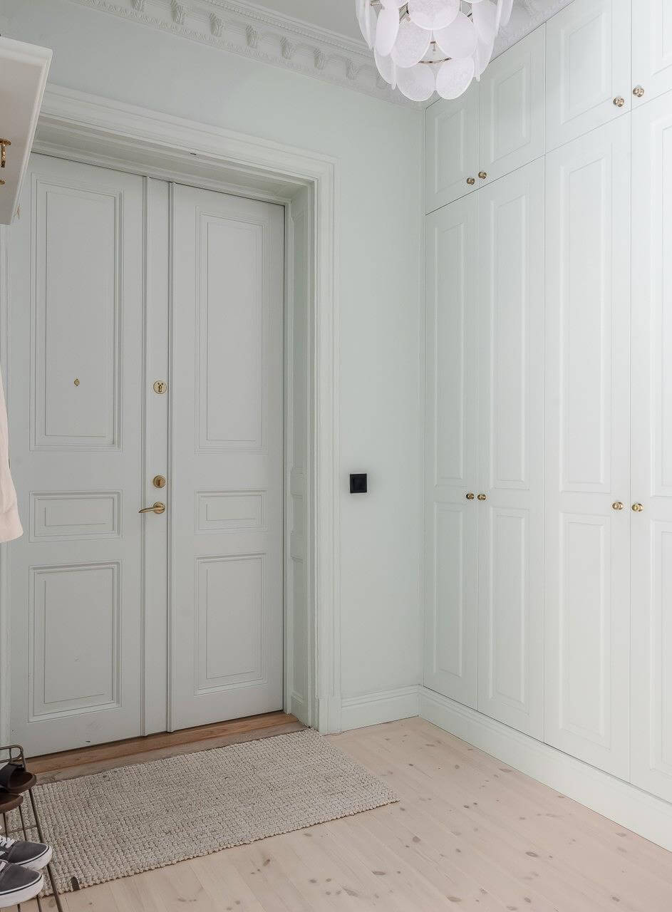 Pastel Colors and Contemporary Design in a Late 19th Century Apartment 20 hall floor to ceiling built-in wardrobes