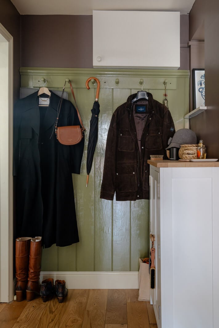 A Muted Color Palette in a Charming Ground Floor Apartment 19 hall green painted paneling