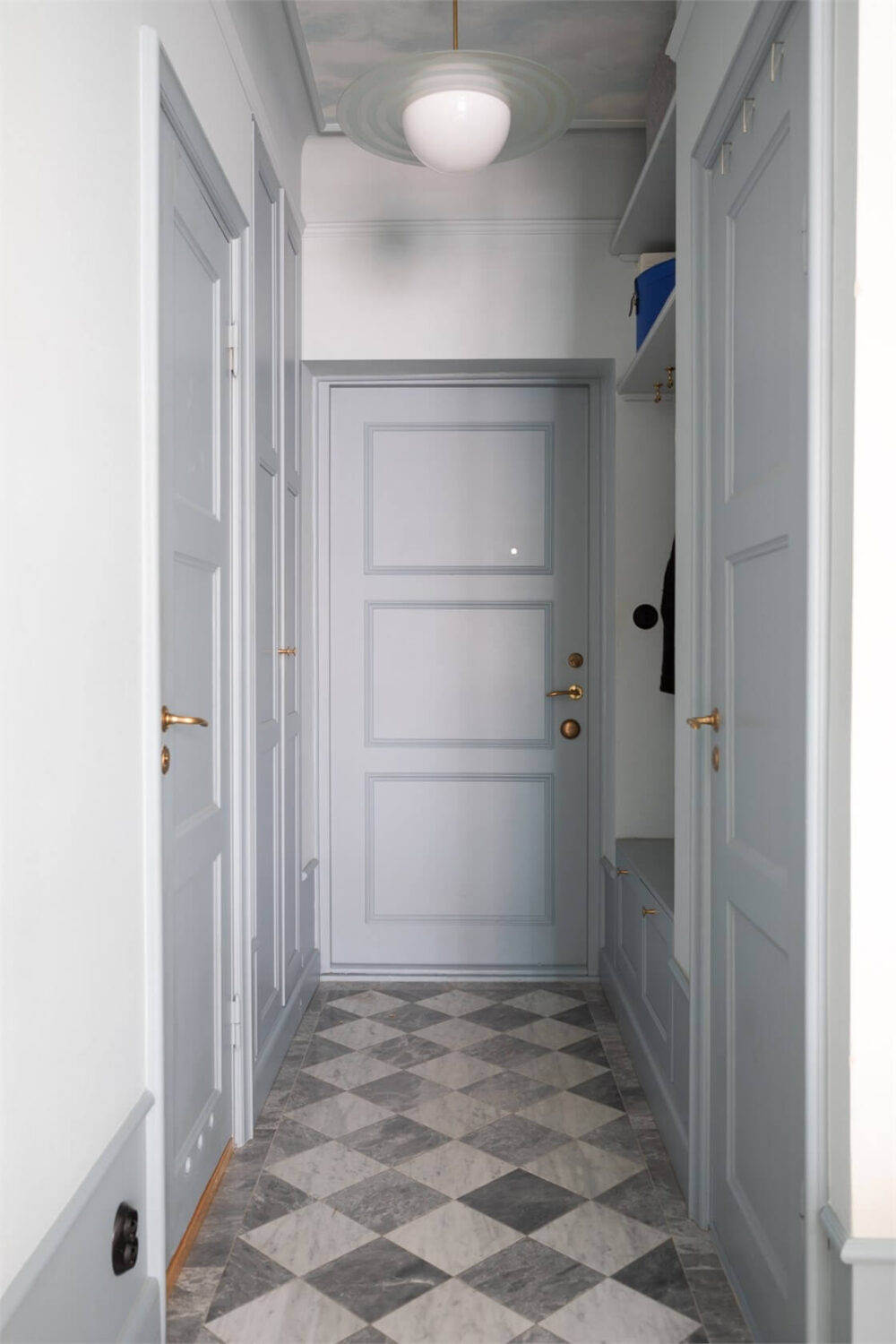 A Small Stockholm Apartment with a Blue Shaker Kitchen 25 hall marble checkerboard floor tiles blue-gray joinery