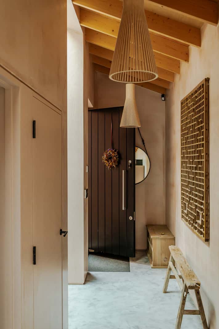 A Japanese-Inspired Timber Home with Views of a Lush Valley 21 hall slanted timber ceiling