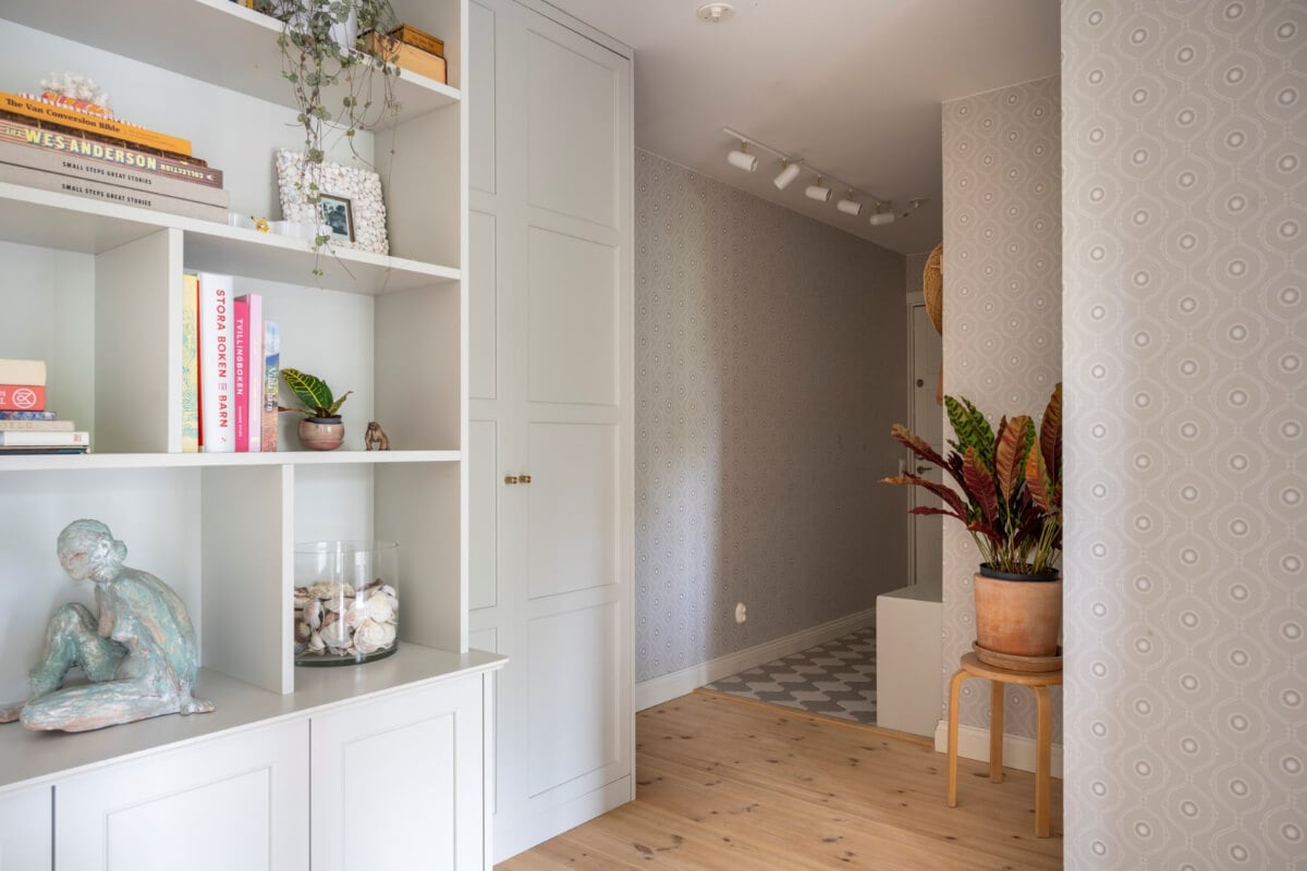 A Light Swedish Apartment with a Green Living Room 13 hall wooden floor and built in cabinets