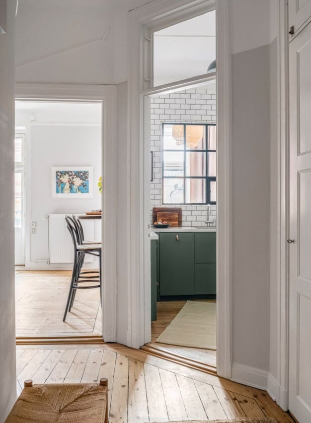 A Small Light-Filled Apartment with a Pink Bedroom 20 hall wooden floor