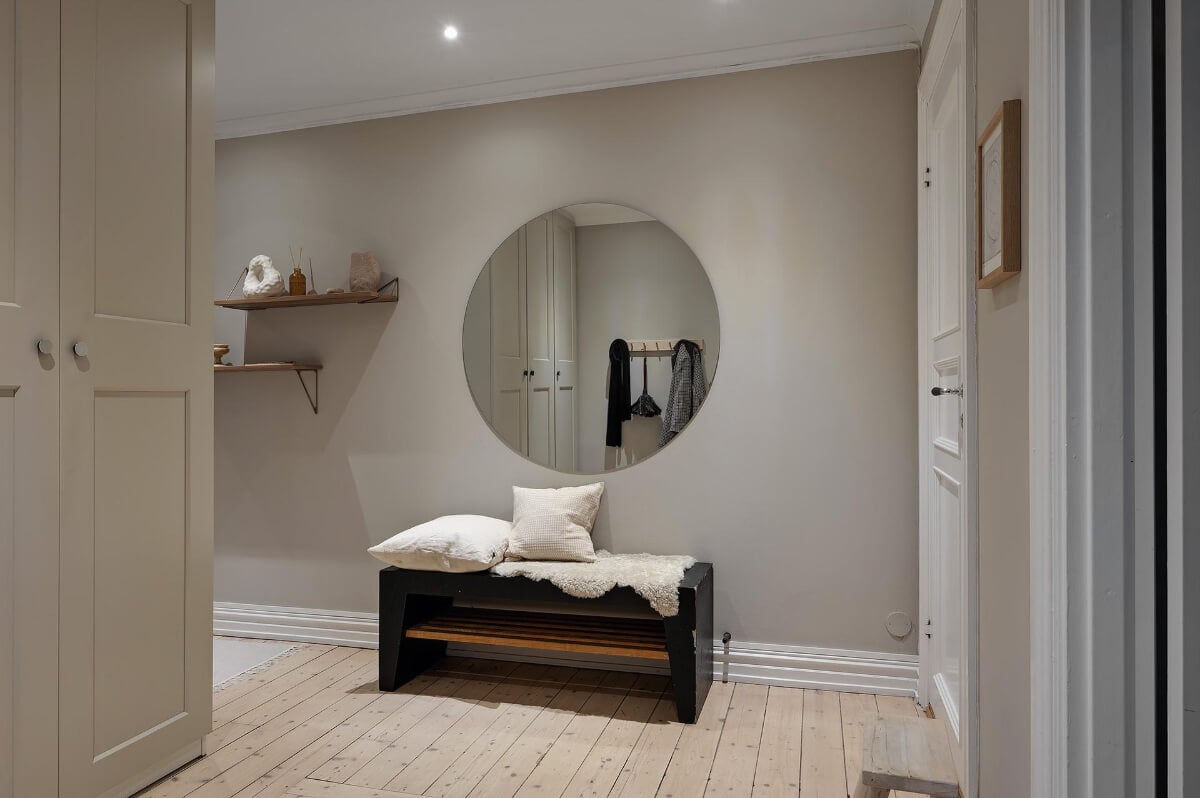 A Gothenburg Apartment with a Small Dark Green Bedroom 25 hallway built-in storage large round mirror