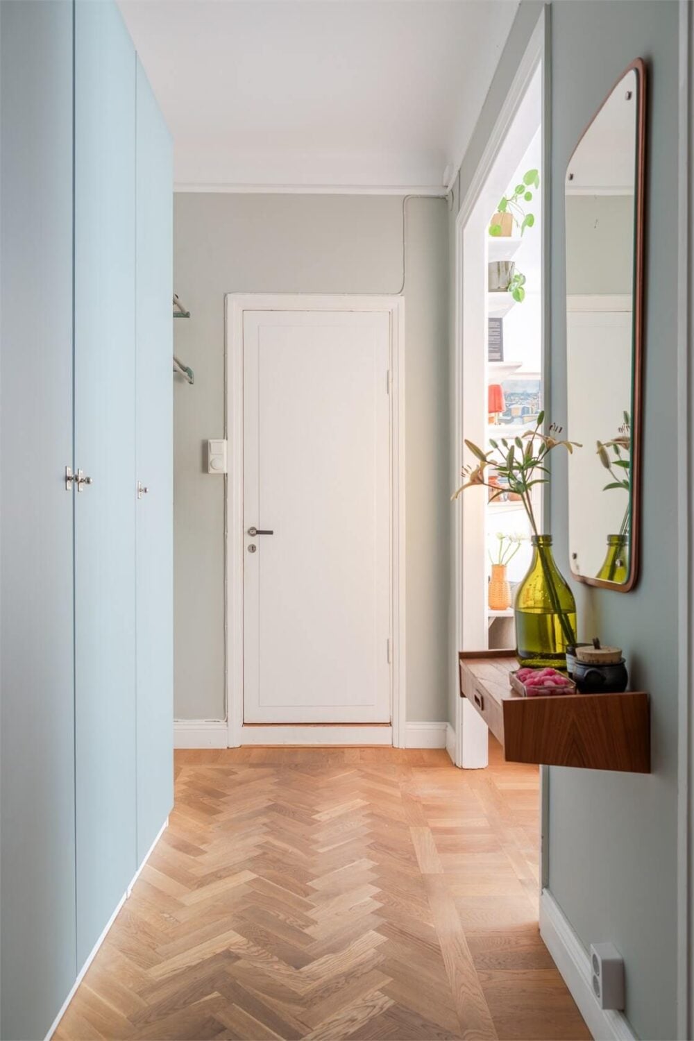 A Small Open-Plan Apartment with Midcentury Furniture 16 hallway built-in wardrobe floating shelf