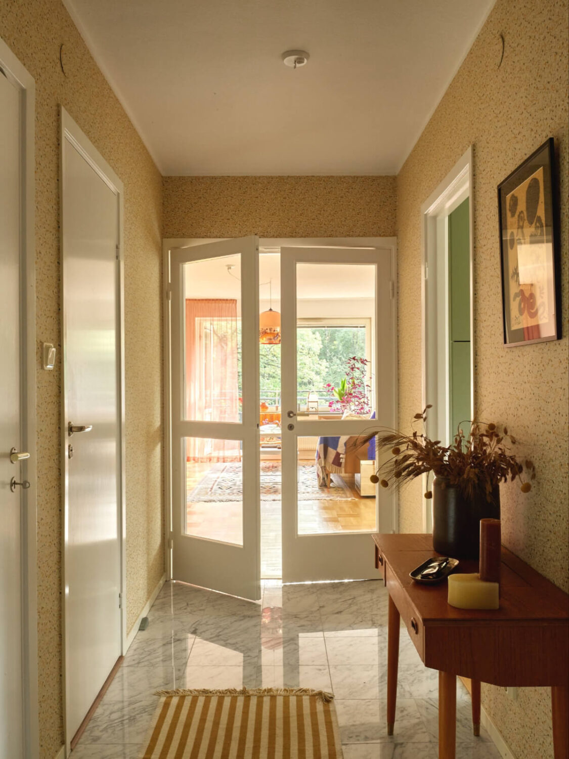 A Lovely Color Palette in a Midcentury Apartment in Sweden 23 hallway marble floor tiles wallpaper