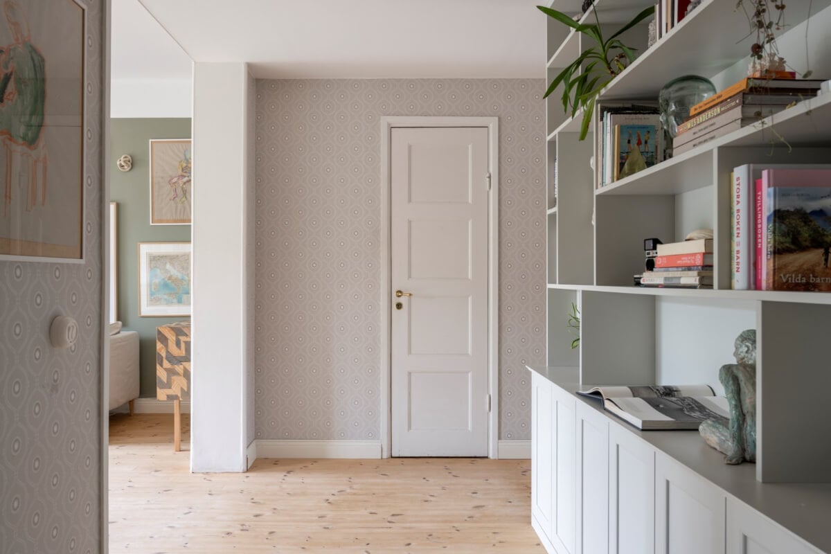 A Light Swedish Apartment with a Green Living Room 15 hallway with bookcases