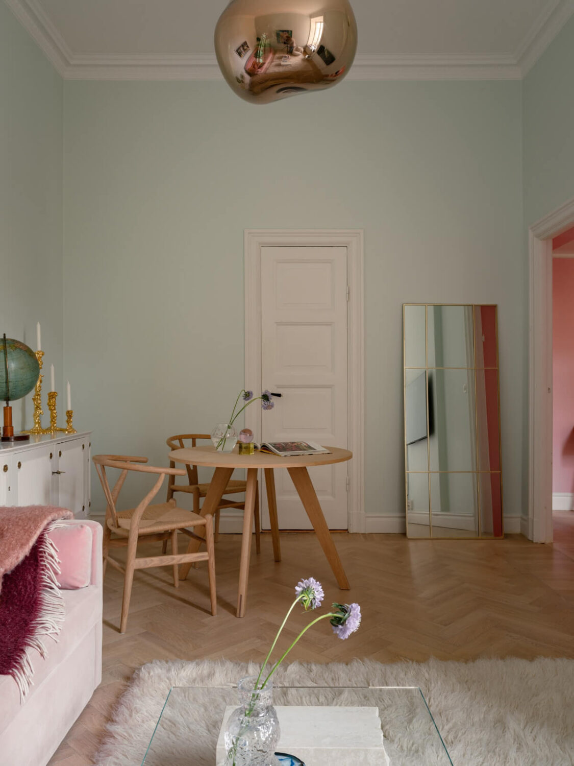 A Small Pink and Blue Apartment with High Ceilings in Stockholm 11 high ceiling living room light blue wall round table