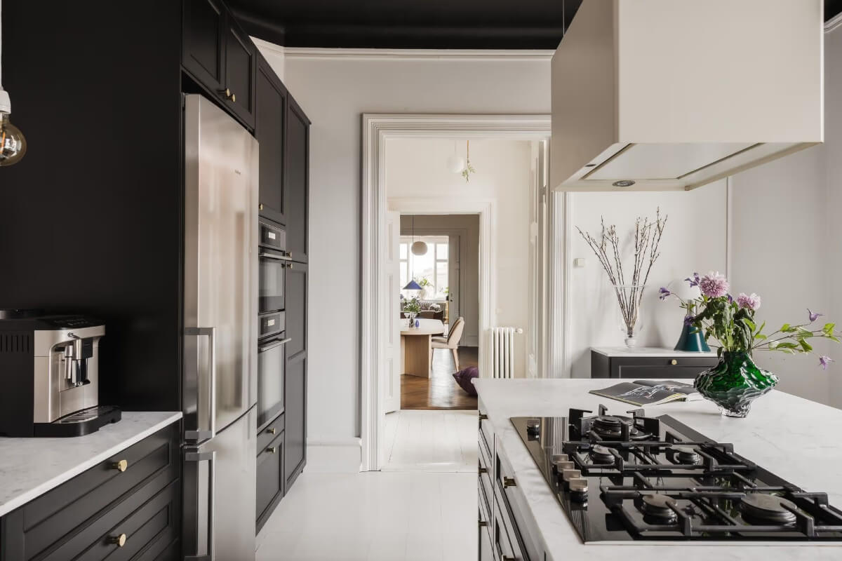 Grand Rooms and Period Features in a Malmö Apartment 15 kitchen black cabinets and ceiling